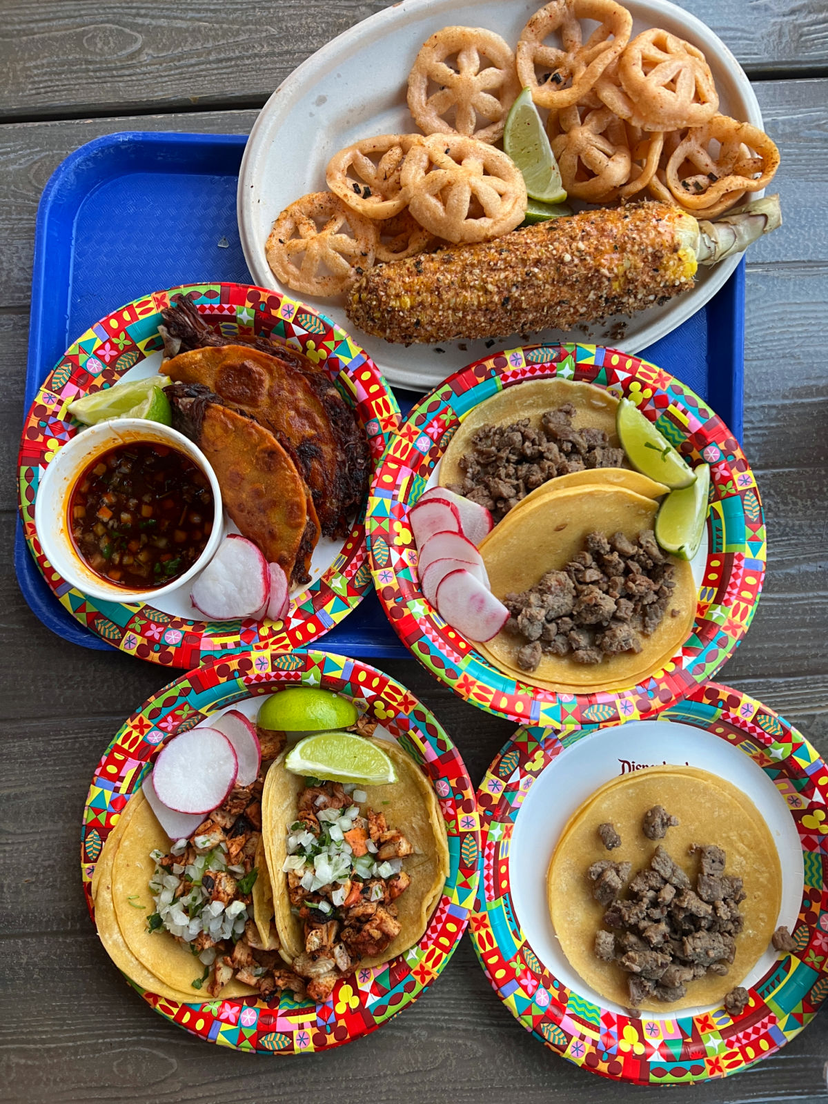 Plates of food from San Fransokyo square on a blue tray.