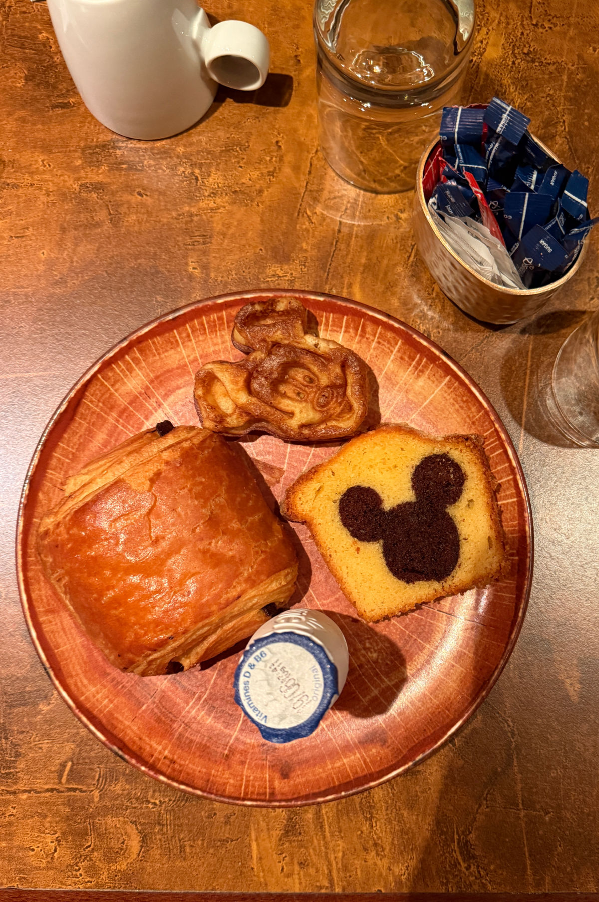 Mickey waffle and pastries on a plate.