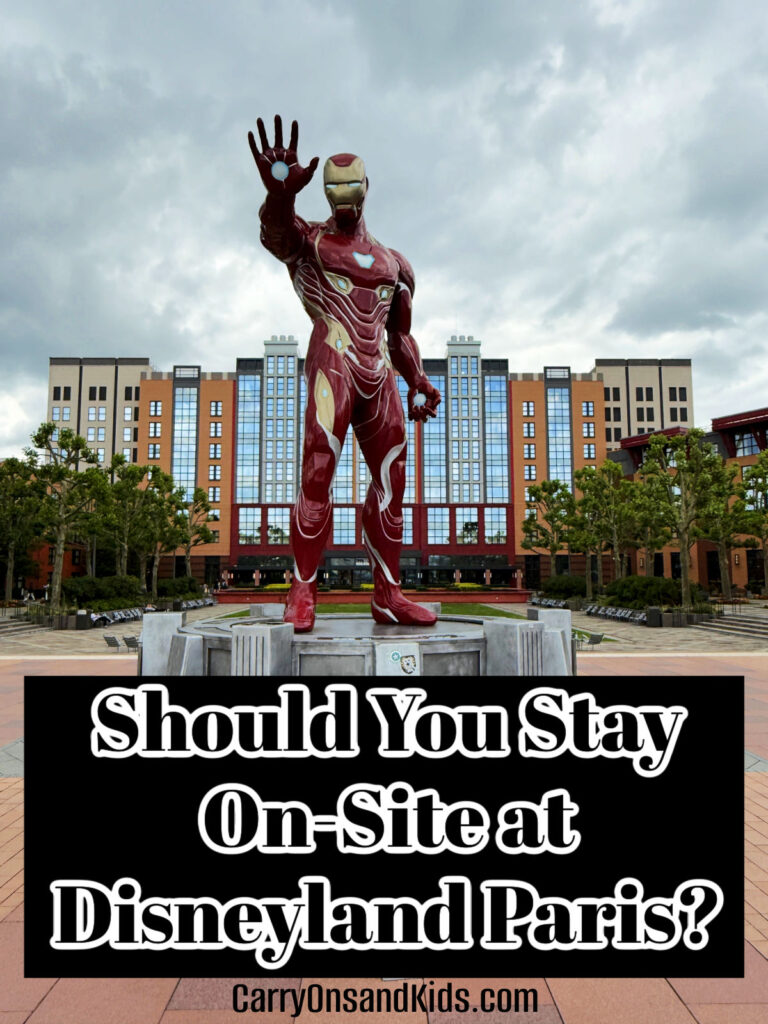 Iron Man statue in front of the New York Hotel in Disneyland Paris with text overlay of post title.