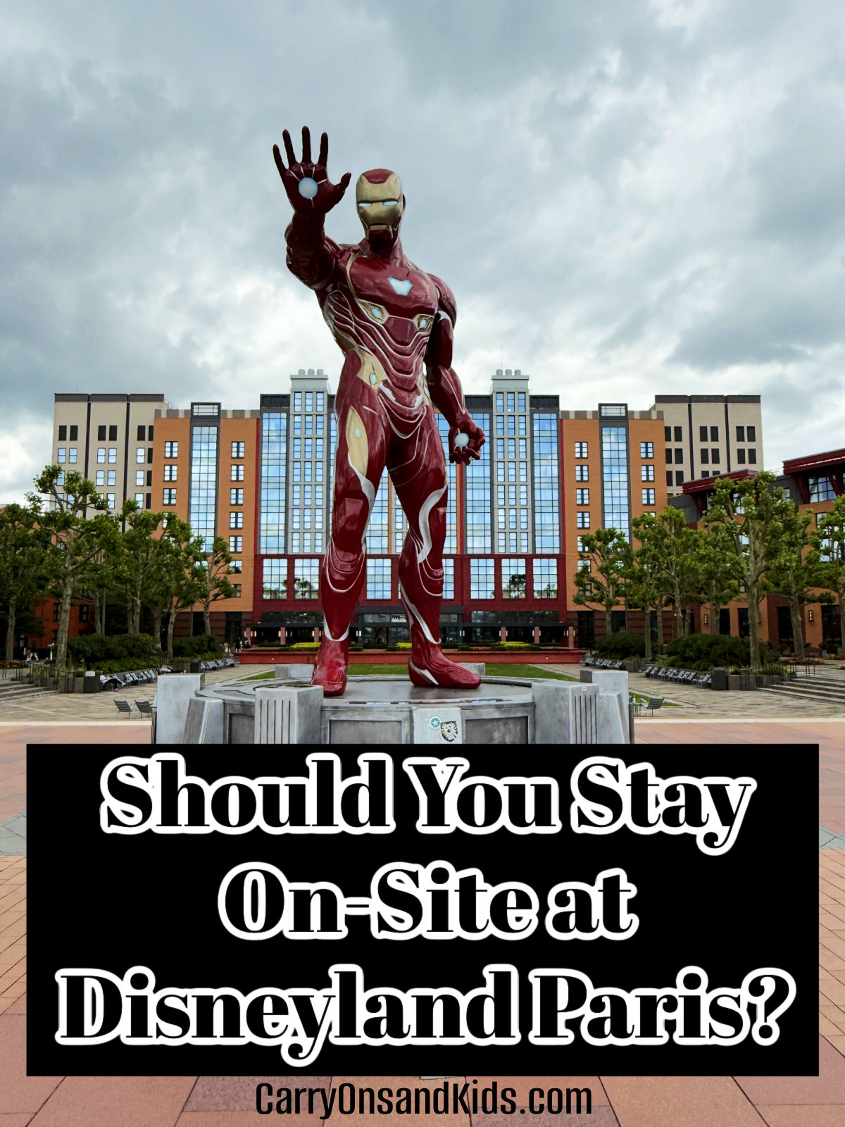 Iron Man statue in front of the New York Hotel in Disneyland Paris with text overlay of post title.